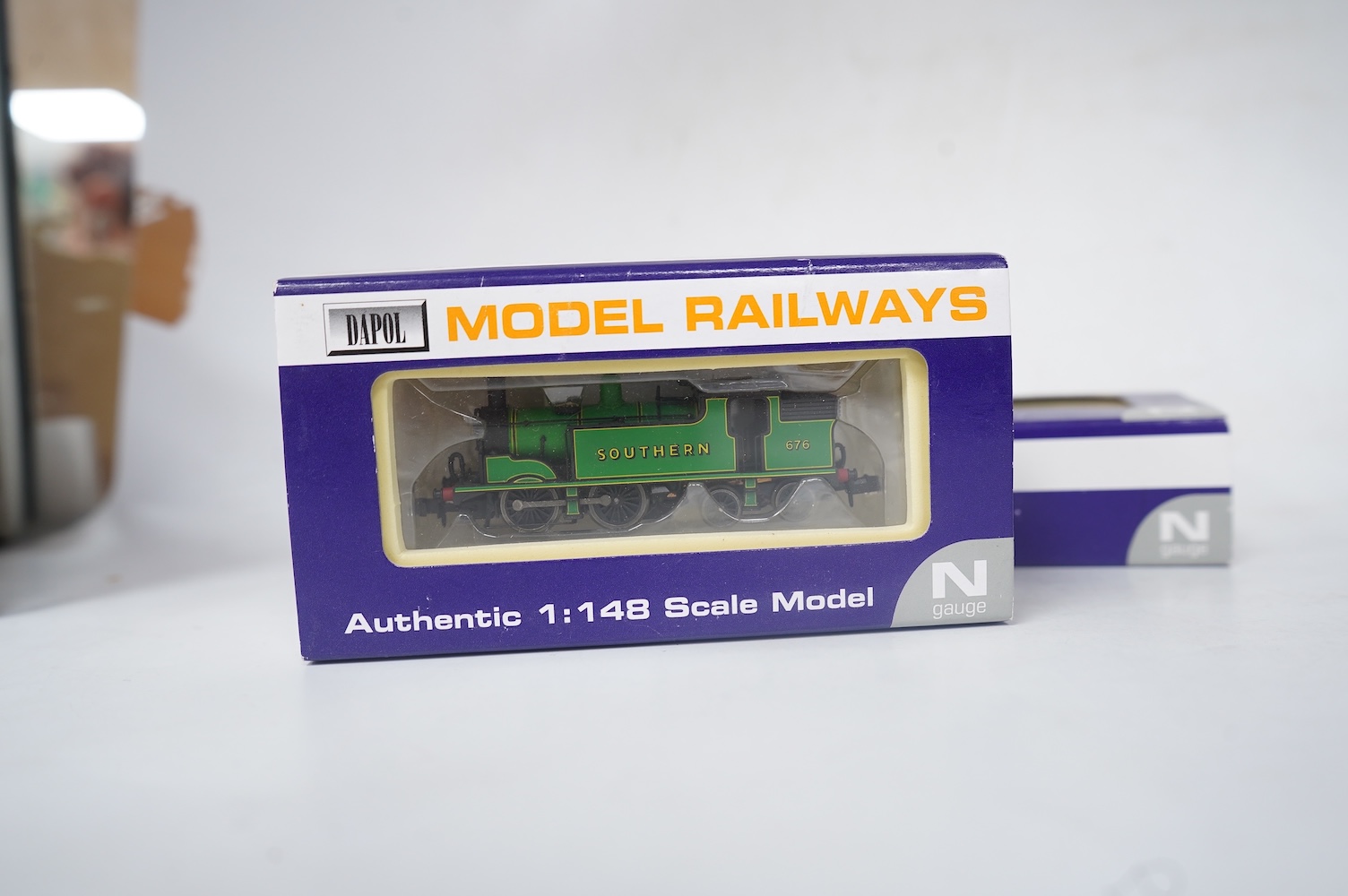 Four boxed Dapol N gauge railway locomotives; two BR Class Q1, both 33040 (ND-076B), one in associated box, a BR Class 14xx, 1458 (ND002) and an SR Class M7, 676 (ND-046). Condition - good.